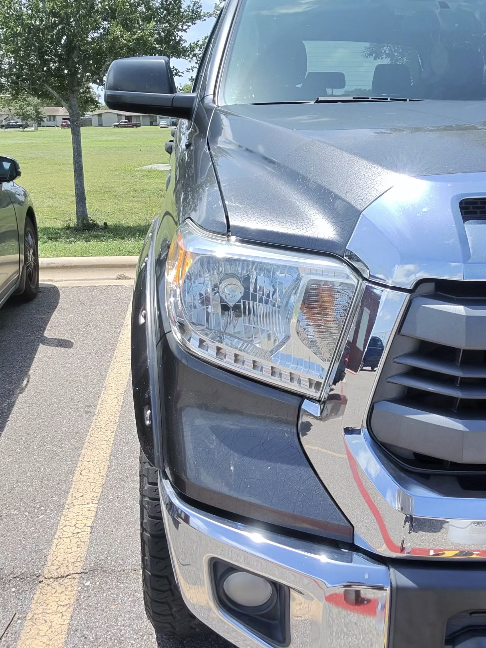 Technician hand-polishing a headlight